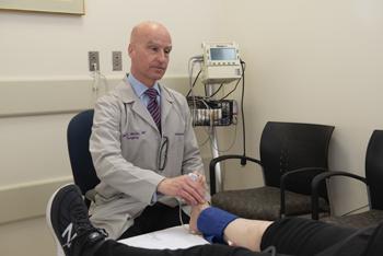 Vascular Surgeon examining patient's foot.