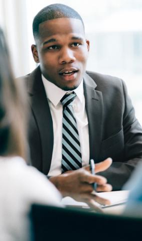 Black man discussing finances with unseen people