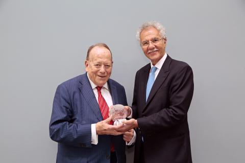 Roger Greenhalgh receives the Society for Vascular Surgery's International Lifetime Achievement Award from Enrico Ascher, in 2018.