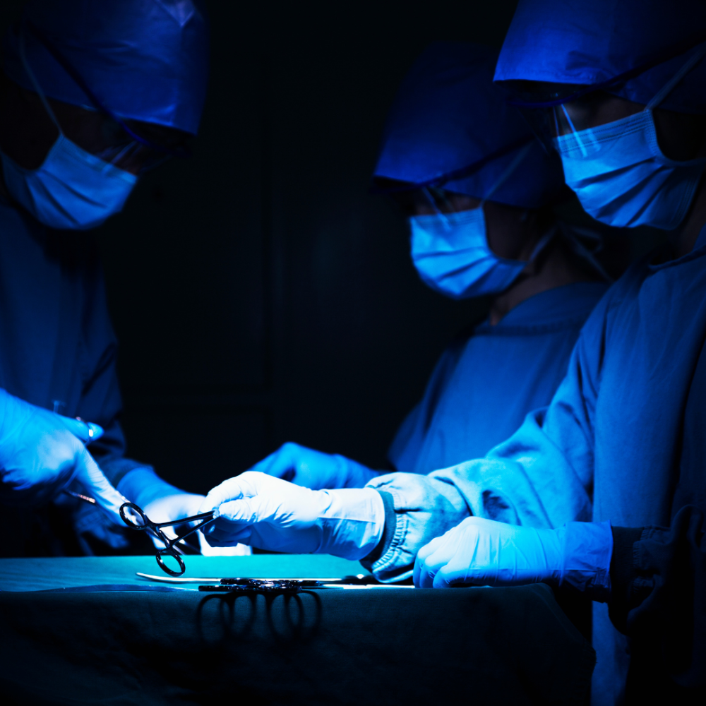 Surgeons Working together in blue-light room