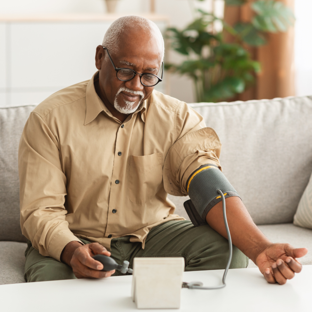 Elderly man checking blood pressure in home