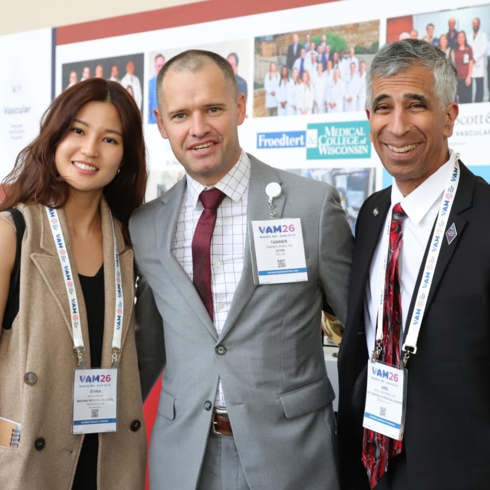 Members standing together and smiling at VAM26